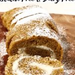 Sliced pumpkin roll on cutting board