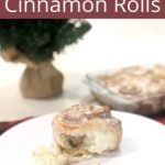 Perfect Christmas Cinnamon Roll on white plate with fork