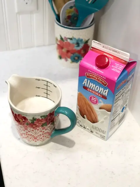 unsweetened almond milk in floral measuring cup