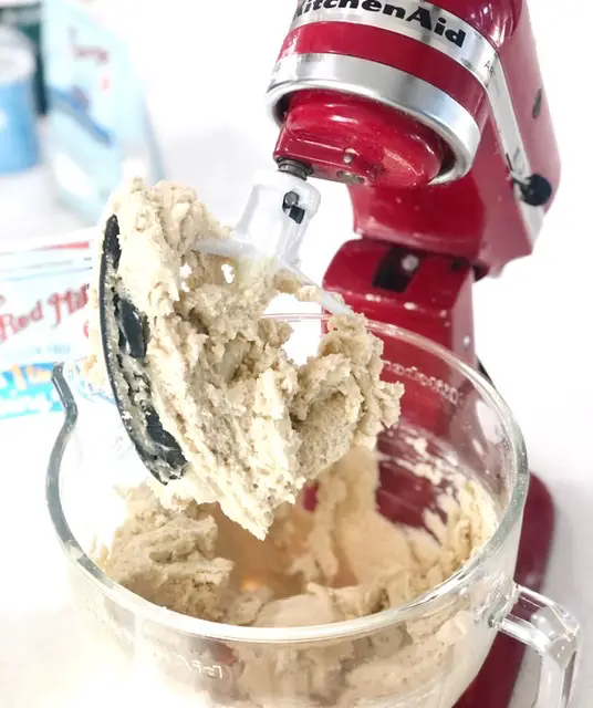 Red kitchen aid mixer with sugar cookie dough