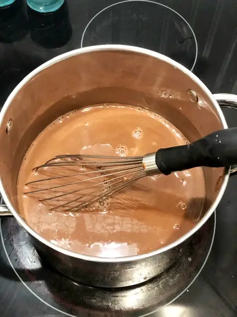 dairy free hot chocolate on stove with whisk