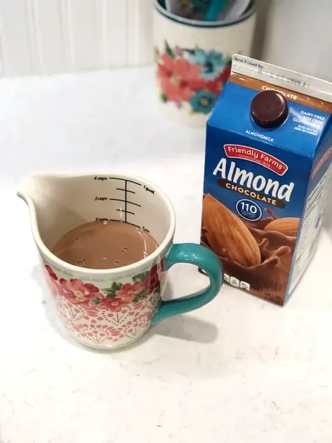 chocolate almond milk in a floral measuring cup