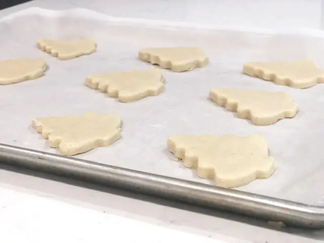 christmas tree sugar cookies on cookie sheet 