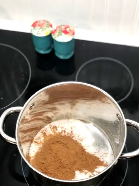 Pot on stove with sugar and cocoa powder