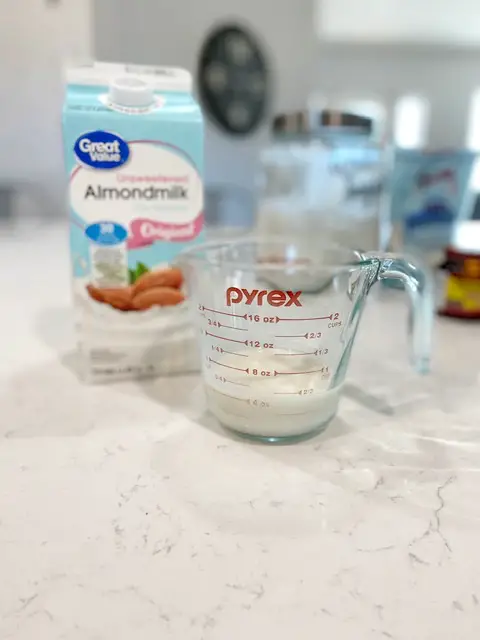 almond milk poured into 2 cup measuring cup