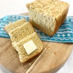 sliced gluten free bread on wooden cutting board