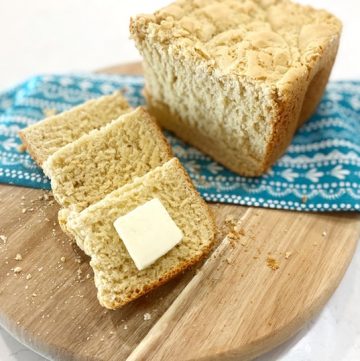 sliced gluten free bread on wooden cutting board