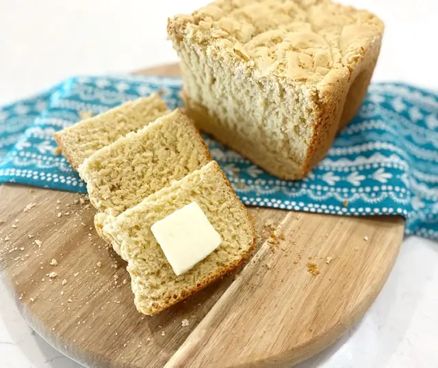 sliced gluten free bread on wooden cutting board 