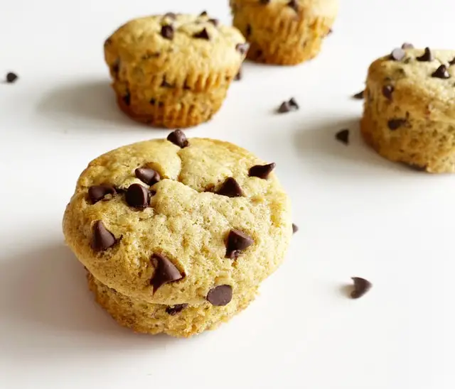 gluten free dairy free banana chocolate chip muffins with chocolate chips on white table
