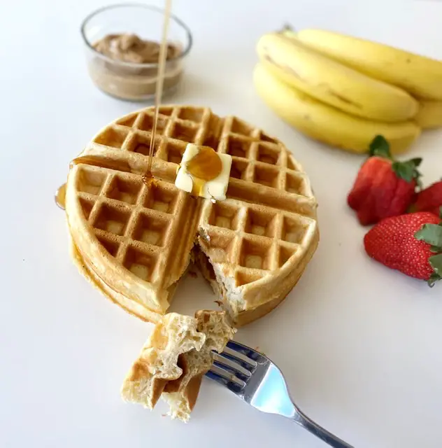 close up of gluten free waffle with syrup being poured on top