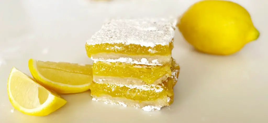 3 stacked gluten free lemon bars with lemon slices