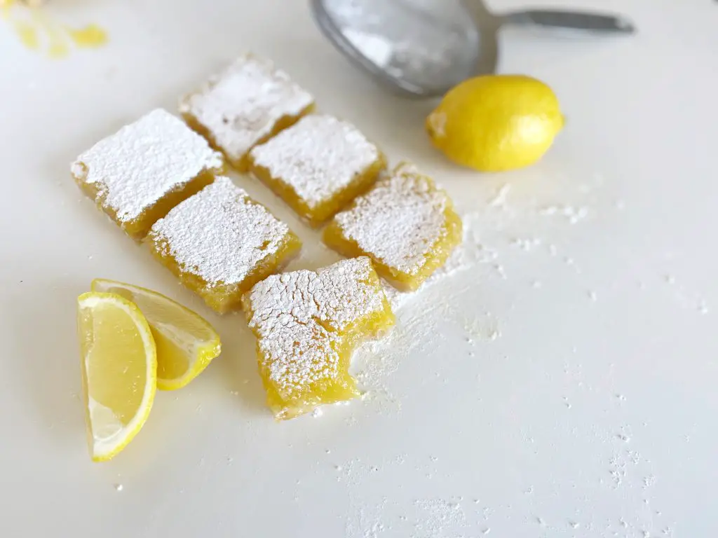 lemon bars on table with lemon slices