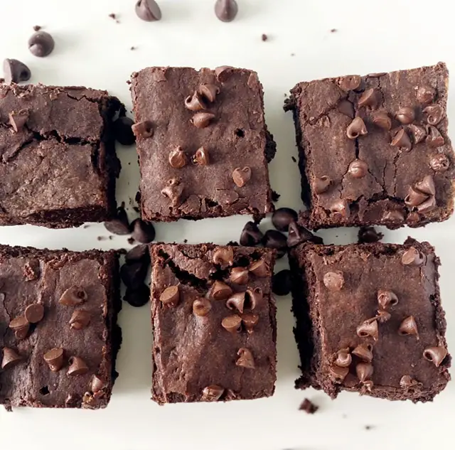 6 gluten free fudge brownies on white table 