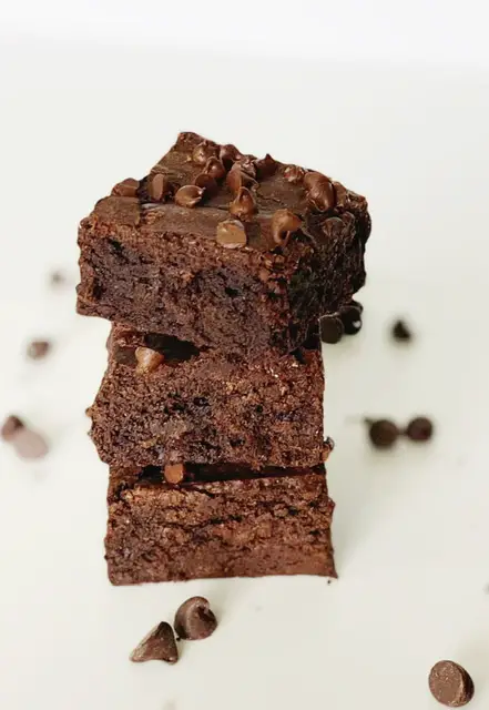 3 of The Best Gluten Free Fudge Brownie stacked on top of each other 
