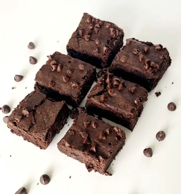 6 gluten free fudge brownies on white table 