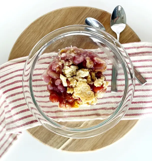 classic gluten free cherry pineapple dump cake on wooden board with two spoons