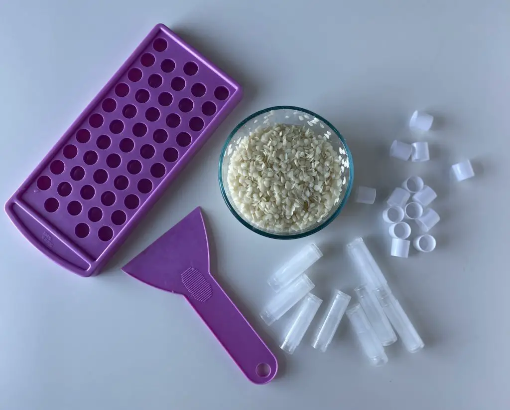 lip balm filling tray, beeswax pellets and plastic chapstick tubes