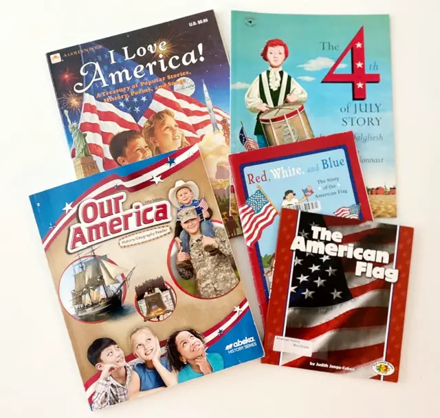 Abeka Academy history book Our America on white table with other patriotic books