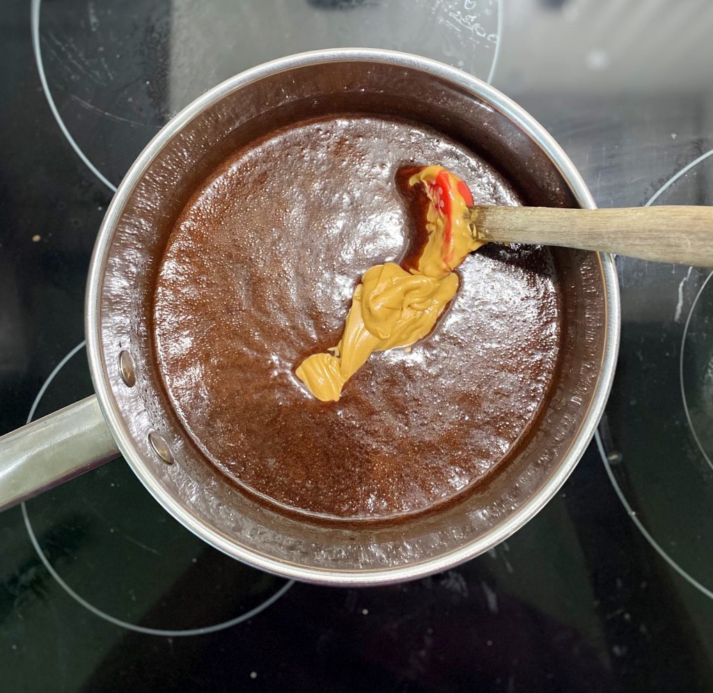 melted cocoa, sugar and peanut butter in stainless steel pot