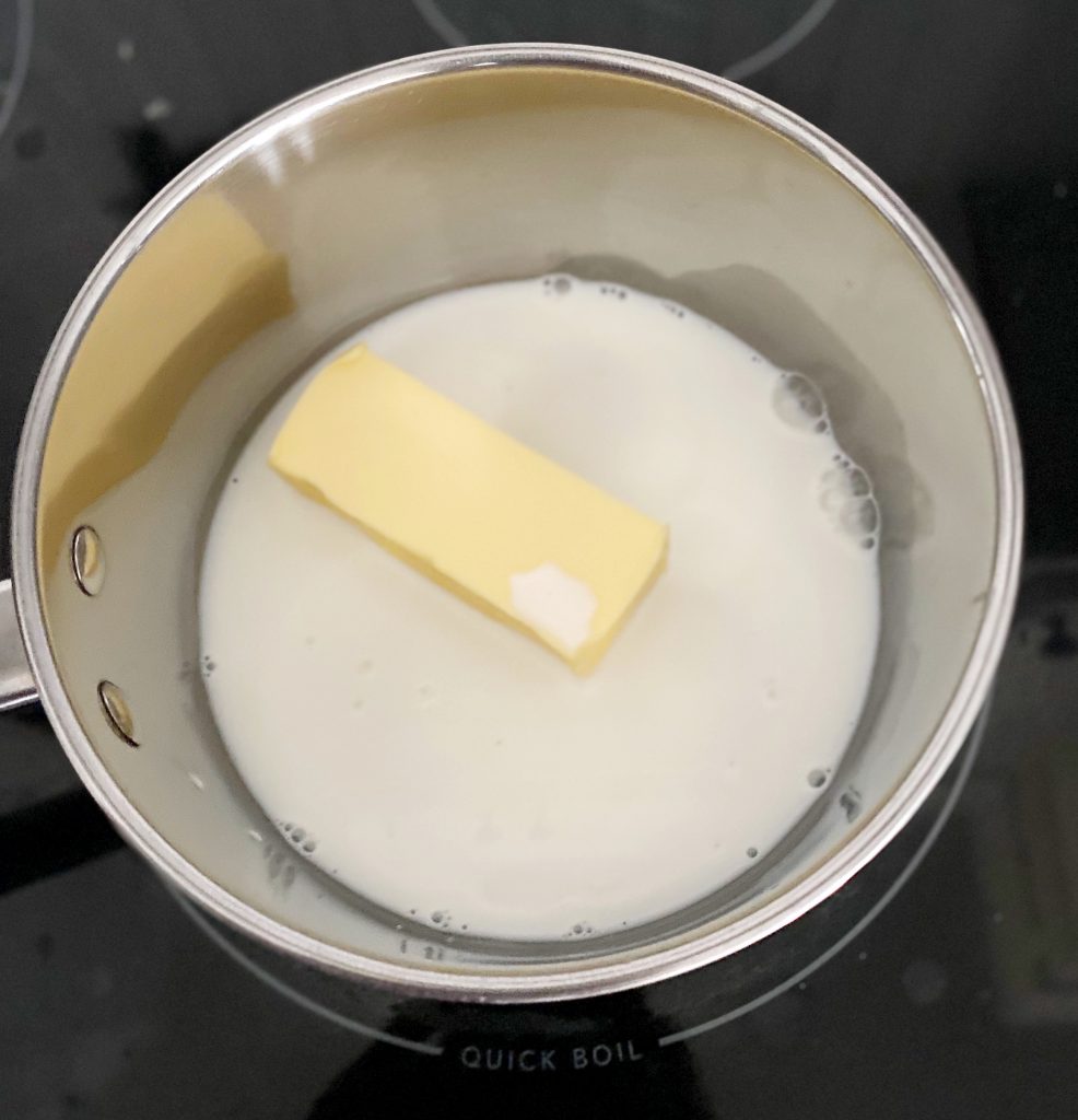 butter and milk in stainless steel pot 