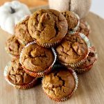 stack of gluten free chocolate chip pumpkin muffins on wooden board