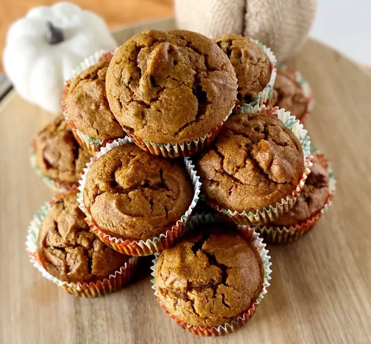 stack of gluten free chocolate chip pumpkin muffins on wooden board