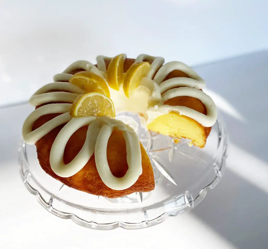 gluten free lemon bundt cake on glass cake stand