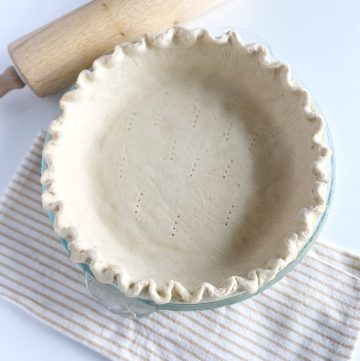 Gluten Free Pie Crust on tea towel with wooden rolling pin